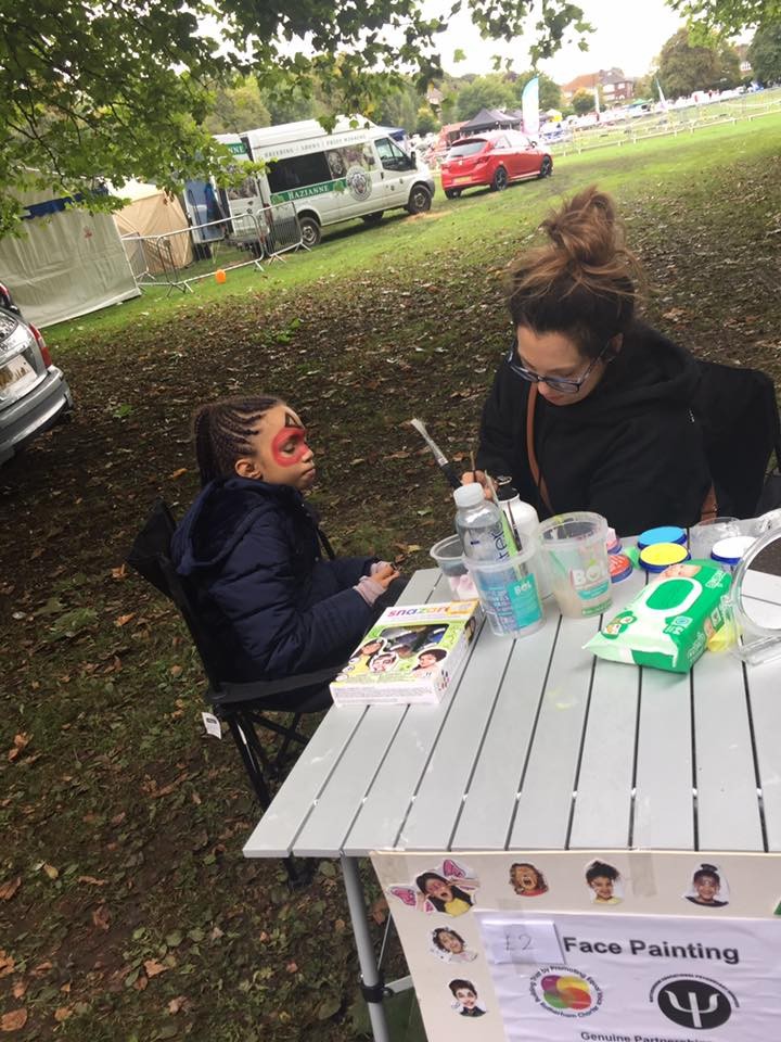 Child having face painting done