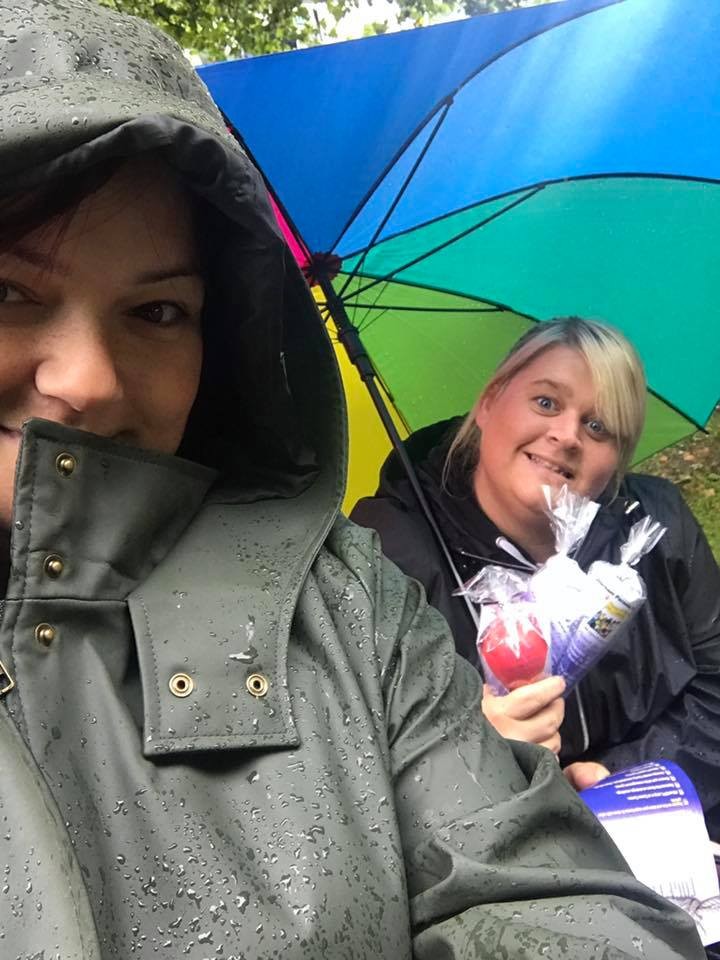 Two ladies pose in the rain 